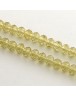 Stiklo karoliukai, apvalūs, plokšti, briaunuoti, skaidrūs, gintaro spalvos, matmenys: 6x4mm, skylė: 1mm; ~100 vnt./gijoje