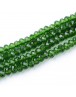 Stiklo karoliukai, apvalūs, plokšti, briaunuoti, skaidrūs, žali, matmenys: 3x2mm; skylė: 0.5mm; apie 200 vnt./gijoje